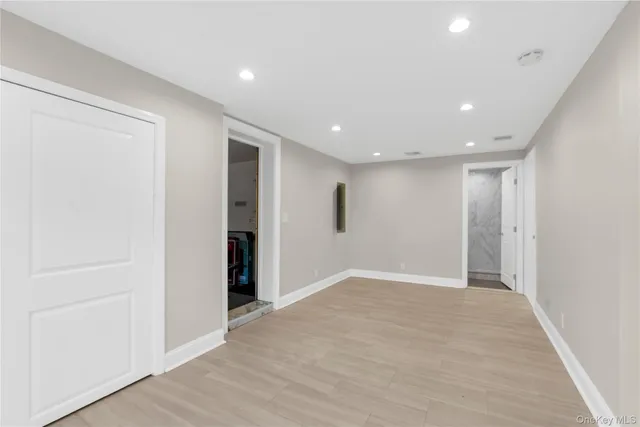 a kitchen with granite countertop white cabinets and window