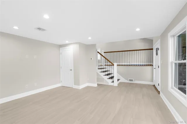 a view of a kitchen with wooden floor and electronic appliances