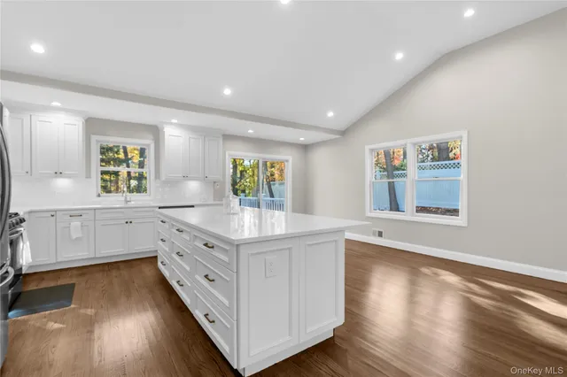 a kitchen with counter top space and window