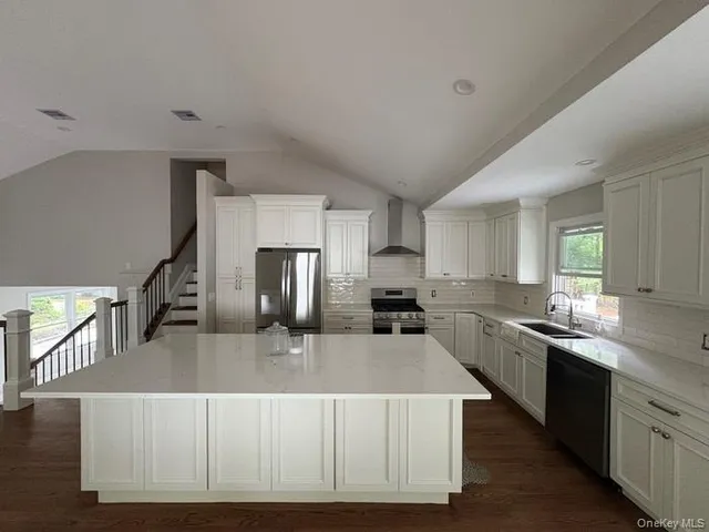 a kitchen with stainless steel appliances granite countertop a sink dishwasher stove top oven and refrigerator