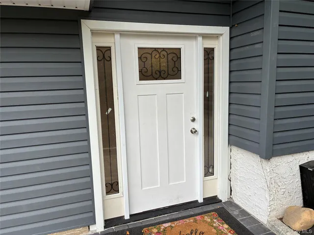 a large kitchen with stainless steel appliances a large counter top a stove a sink and a refrigerator