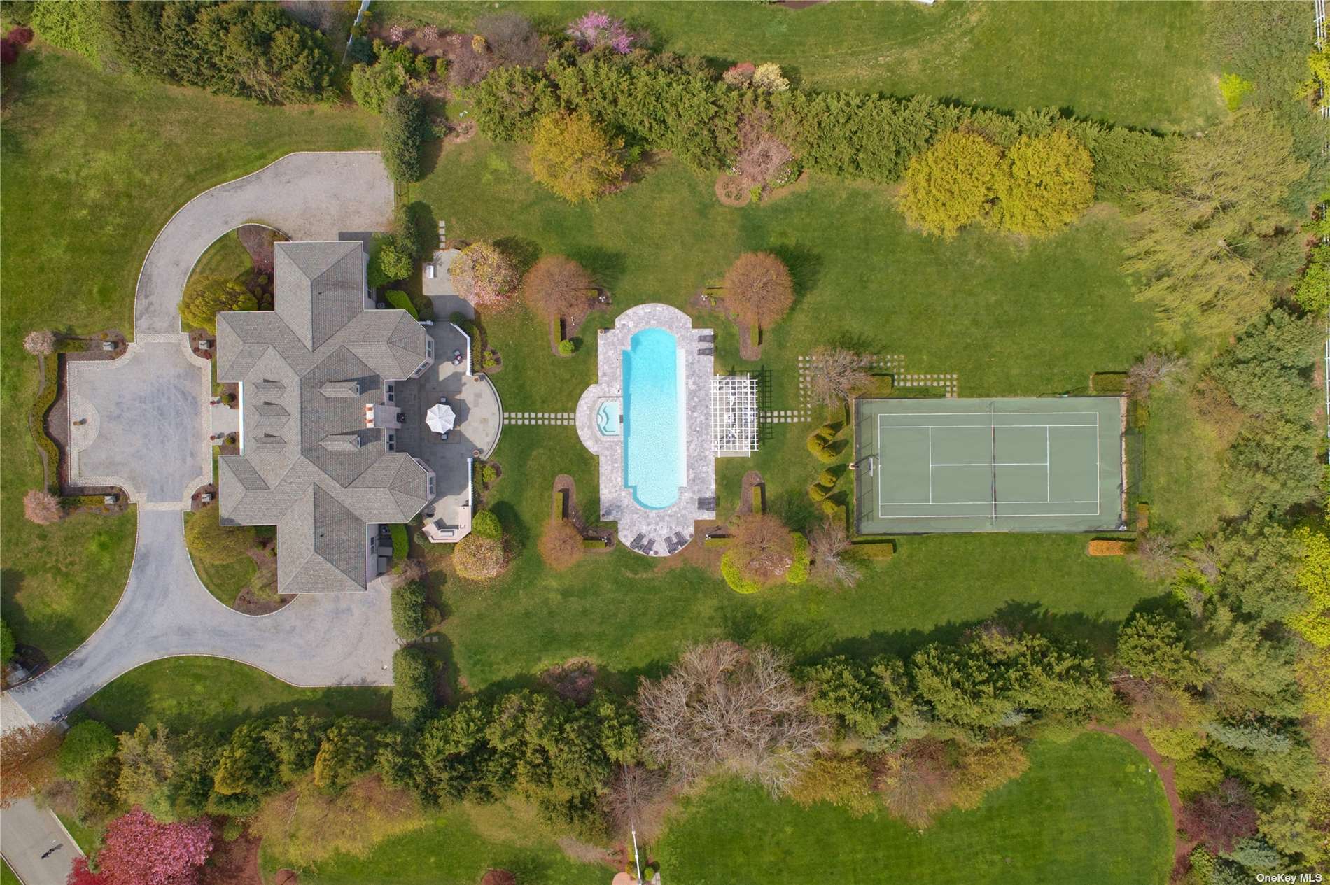 an aerial view of residential house with outdoor space and swimming pool