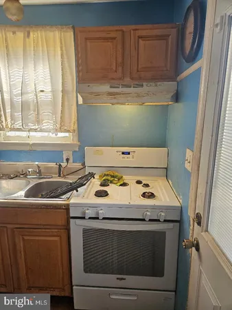a kitchen with a stove and a sink