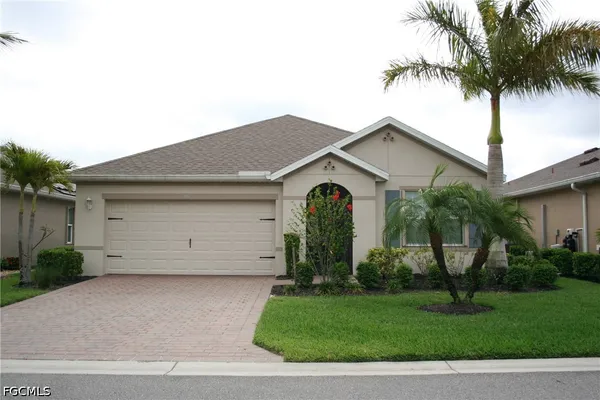 a front view of house with a garden