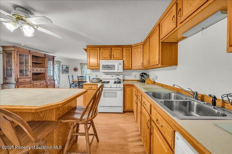 3886 Bow Bridge Road Friendsville, PA 18818 - Photo 23 of 71 a kitchen that has a sink and a stove