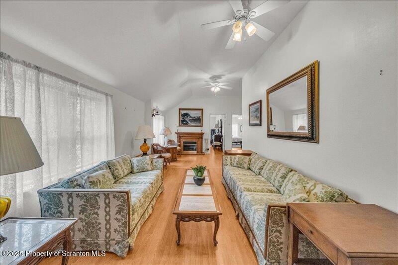 3886 Bow Bridge Road Friendsville, PA 18818 - Photo 28 of 71 a living room with furniture and a chandelier