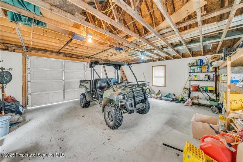 3886 Bow Bridge Road Friendsville, PA 18818 - Photo 58 of 71 a view of a garage with parked cars