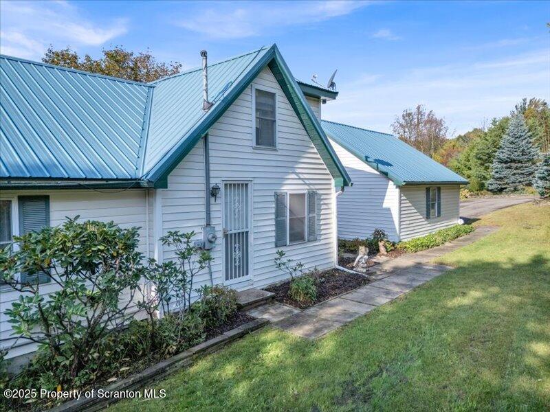 3886 Bow Bridge Road Friendsville, PA 18818 - Photo 6 of 71 a front view of a house with garden