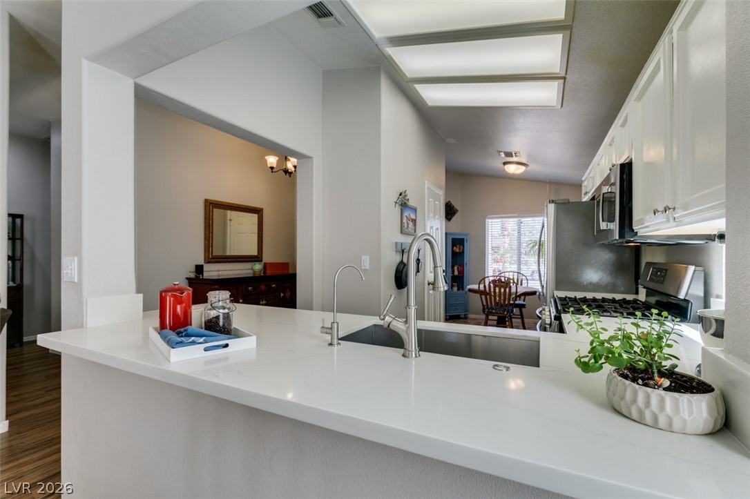 2187 Chapman Ranch Drive Henderson, NV 89012 - Photo 9 of 26 This bright kitchen features a clean aesthetic with modern appliances and ample counter space.