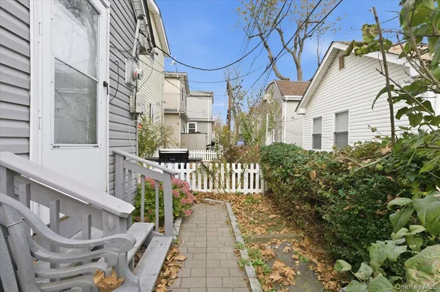 a backyard of a house with barbeque oven table and chairs