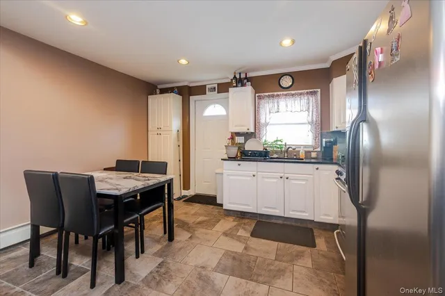 a kitchen with granite countertop cabinets and refrigerator
