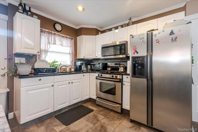 a kitchen with stainless steel appliances granite countertop a refrigerator sink and microwave