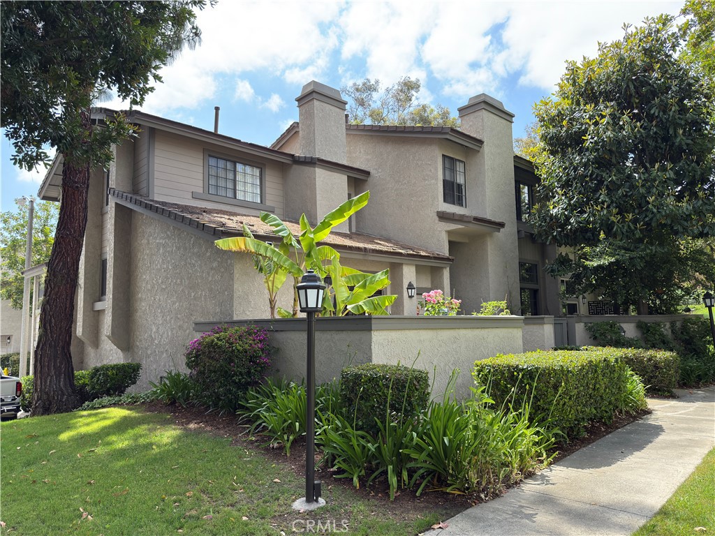 8 Misty Shadow, Unit 3 Irvine, CA 92603 - Photo 1 of 1 a view of a house with a yard and a large tree