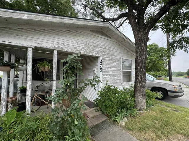 a couple of cars parked in front of a house