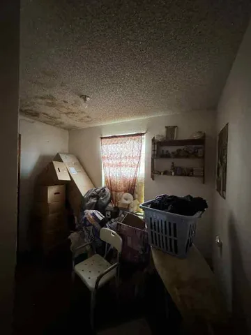 a bed sitting in a room next to a window