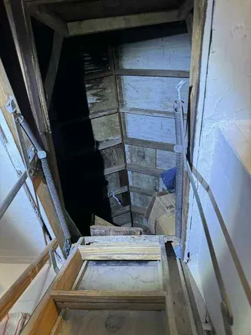 a view of a patio with chairs and a barbeque