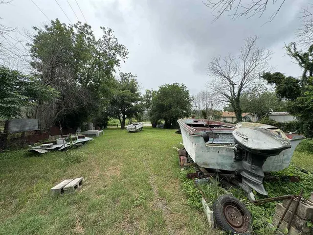 a backyard of a house with table and sofas