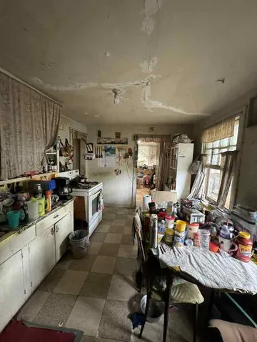 a kitchen with lots of counter top space appliances and furniture