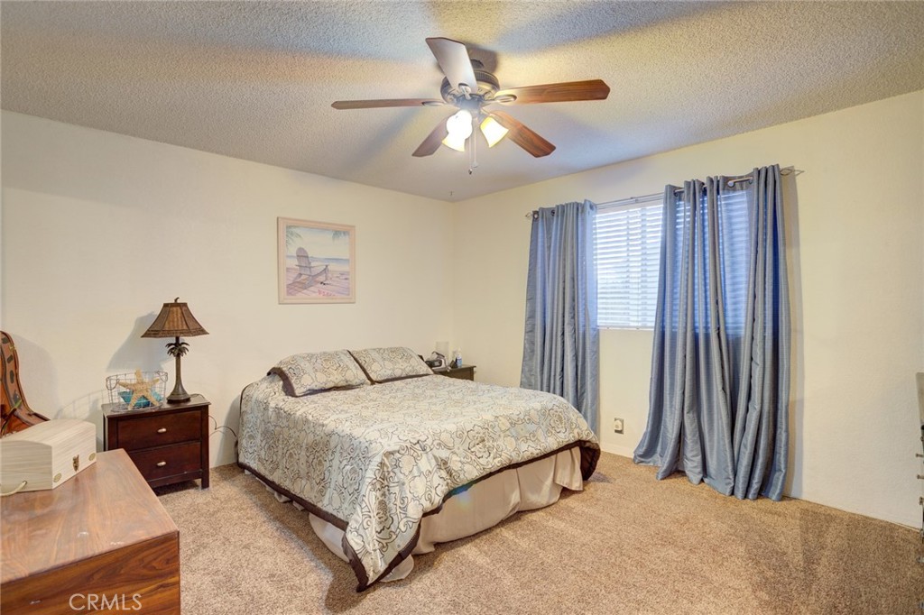 1165 Maple Street, Unit E Arroyo Grande, CA 93420 - Photo 20 of 50 a bedroom with a bed and a chandelier