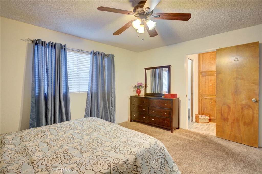 1165 Maple Street, Unit E Arroyo Grande, CA 93420 - Photo 23 of 50 a bedroom with a bed and a chandelier