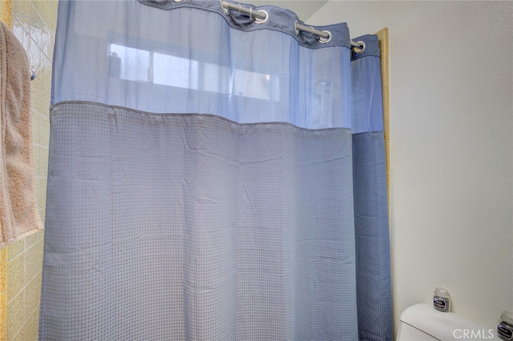 1165 Maple Street, Unit E Arroyo Grande, CA 93420 - Photo 26 of 50 a bathroom with a shower curtain and a sink