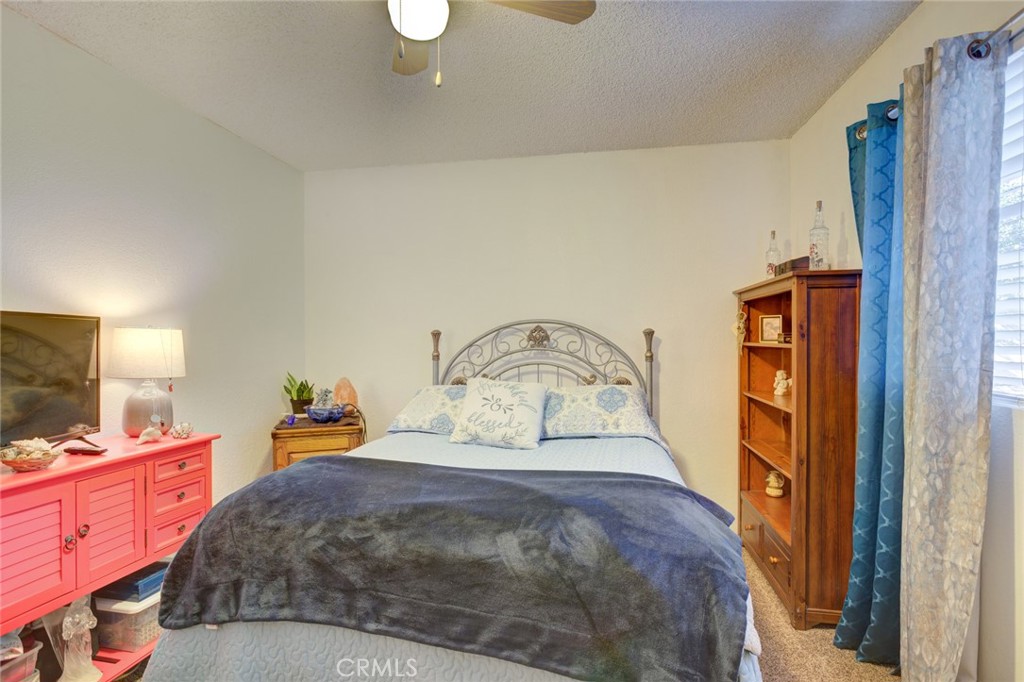 1165 Maple Street, Unit E Arroyo Grande, CA 93420 - Photo 31 of 50 a bedroom with a bed and a flat tv screen on dresser