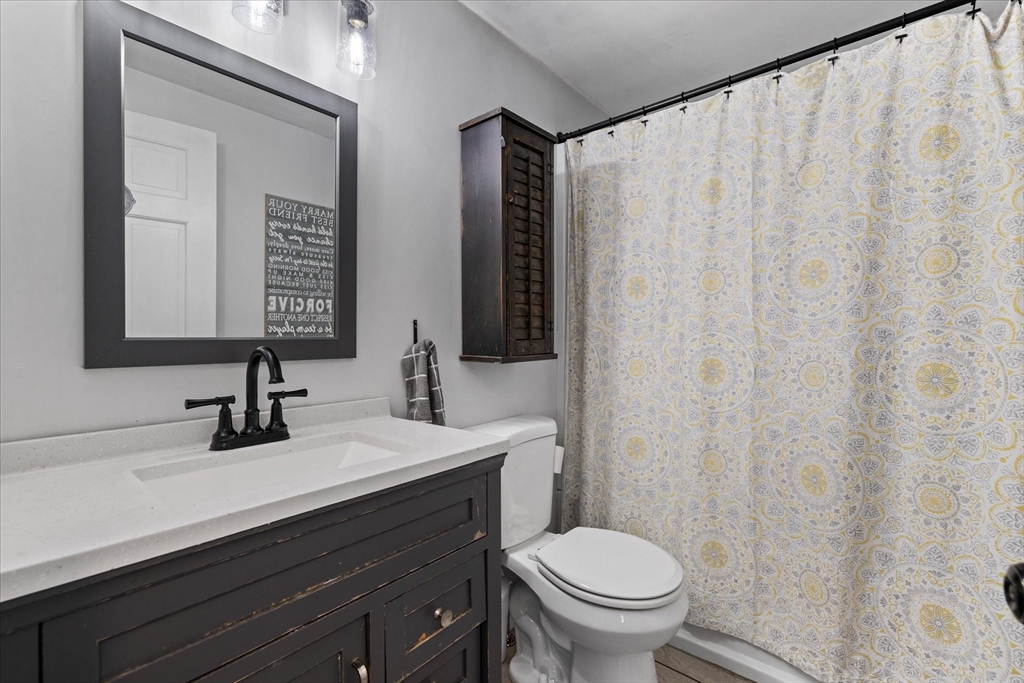 514 West Street Gardner, MA 01440 - Photo 12 of 37 a bathroom with a sink a toilet and a mirror