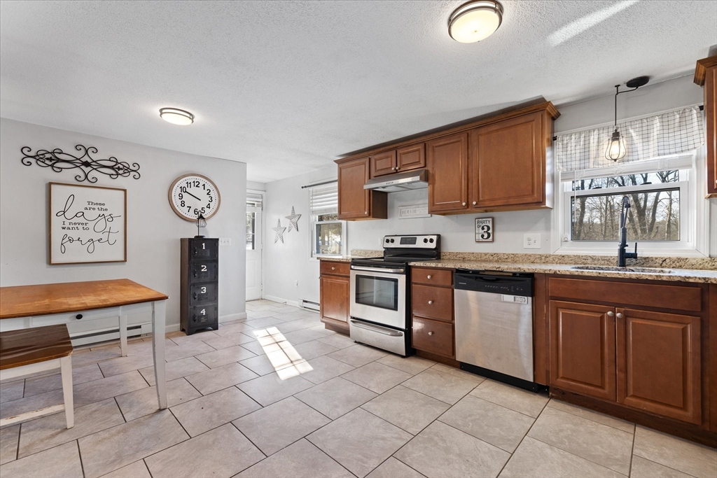 514 West Street Gardner, MA 01440 - Photo 6 of 37 a kitchen with stainless steel appliances granite countertop a stove sink and cabinets
