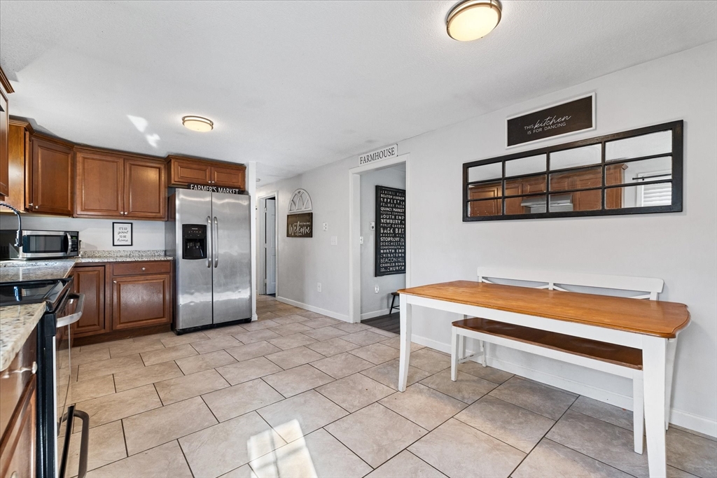514 West Street Gardner, MA 01440 - Photo 8 of 37 a kitchen with stainless steel appliances granite countertop a refrigerator and a stove top oven