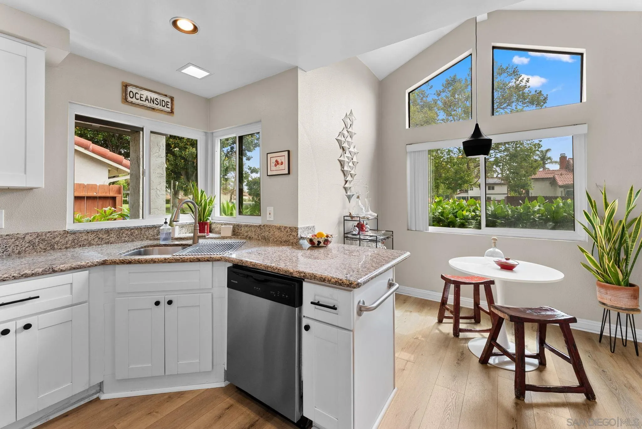 4444 Silver Birch Way Oceanside, CA 92057 - Photo 11 of 54 a view of a kitchen counter top space with a sink and wooden floor