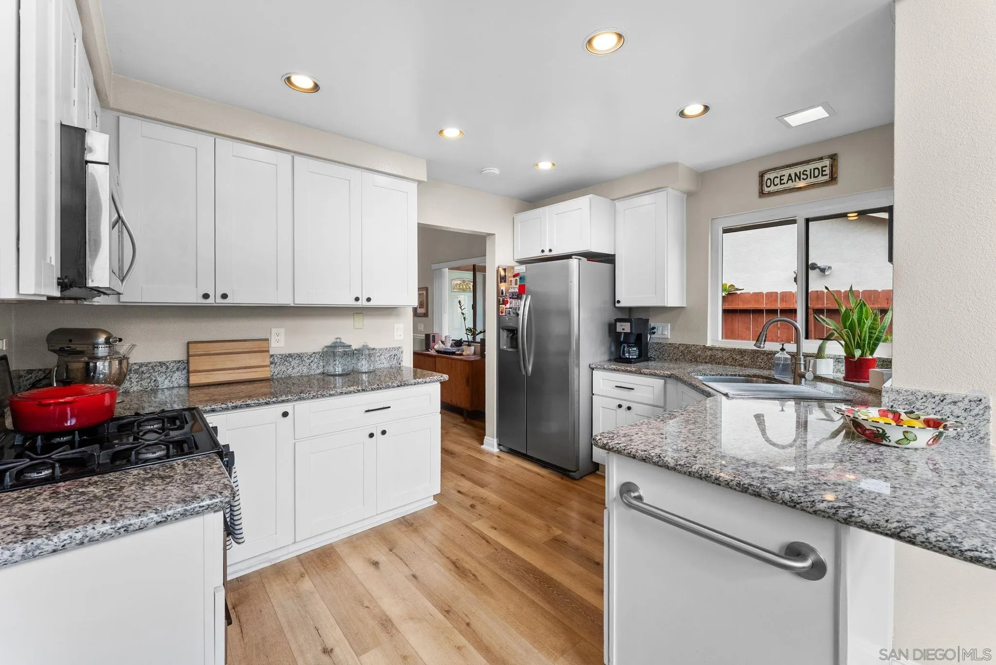 4444 Silver Birch Way Oceanside, CA 92057 - Photo 13 of 54 a kitchen with granite countertop a sink stove and refrigerator