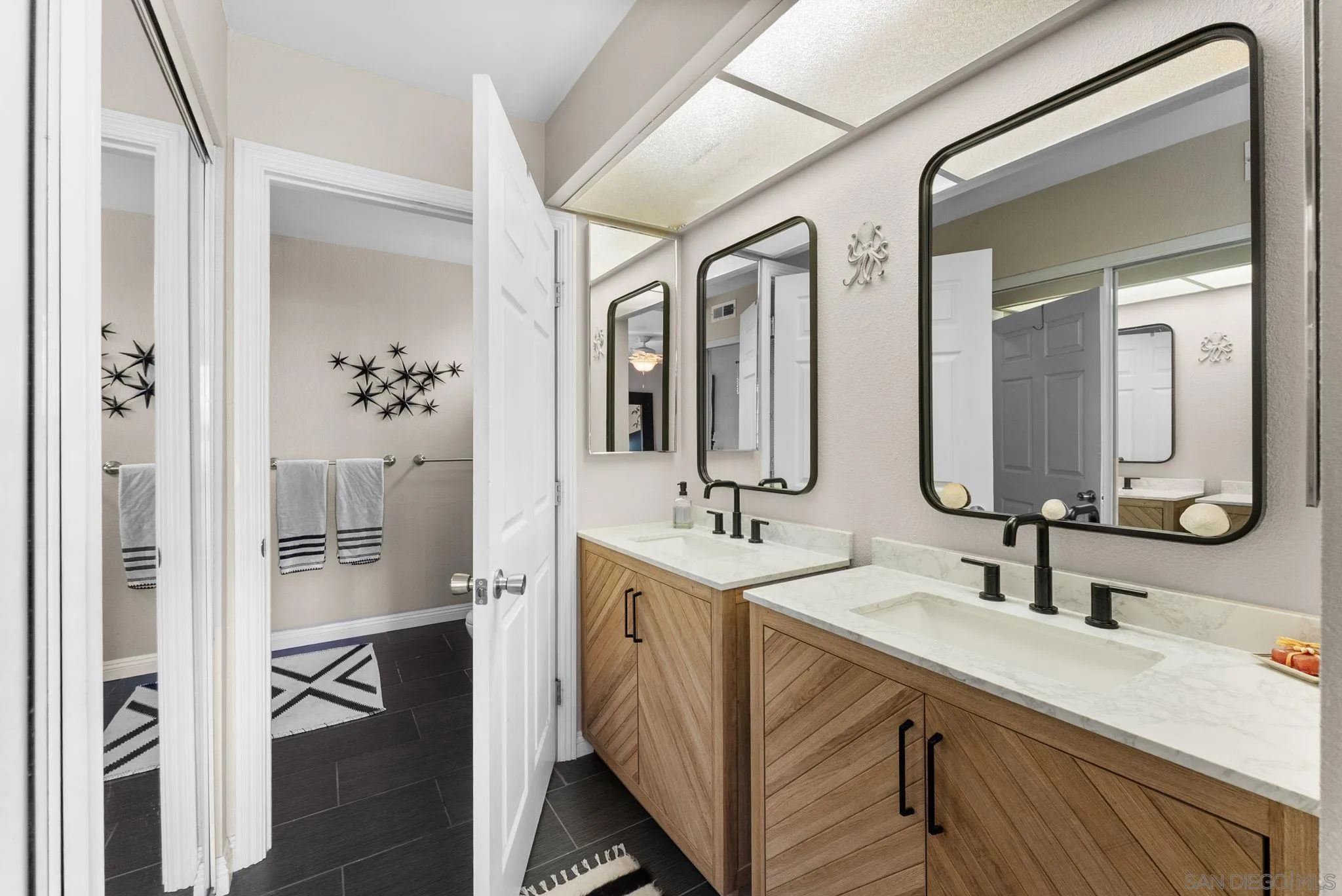 4444 Silver Birch Way Oceanside, CA 92057 - Photo 18 of 54 a en suite bathroom with a double vanity sink a mirror and a