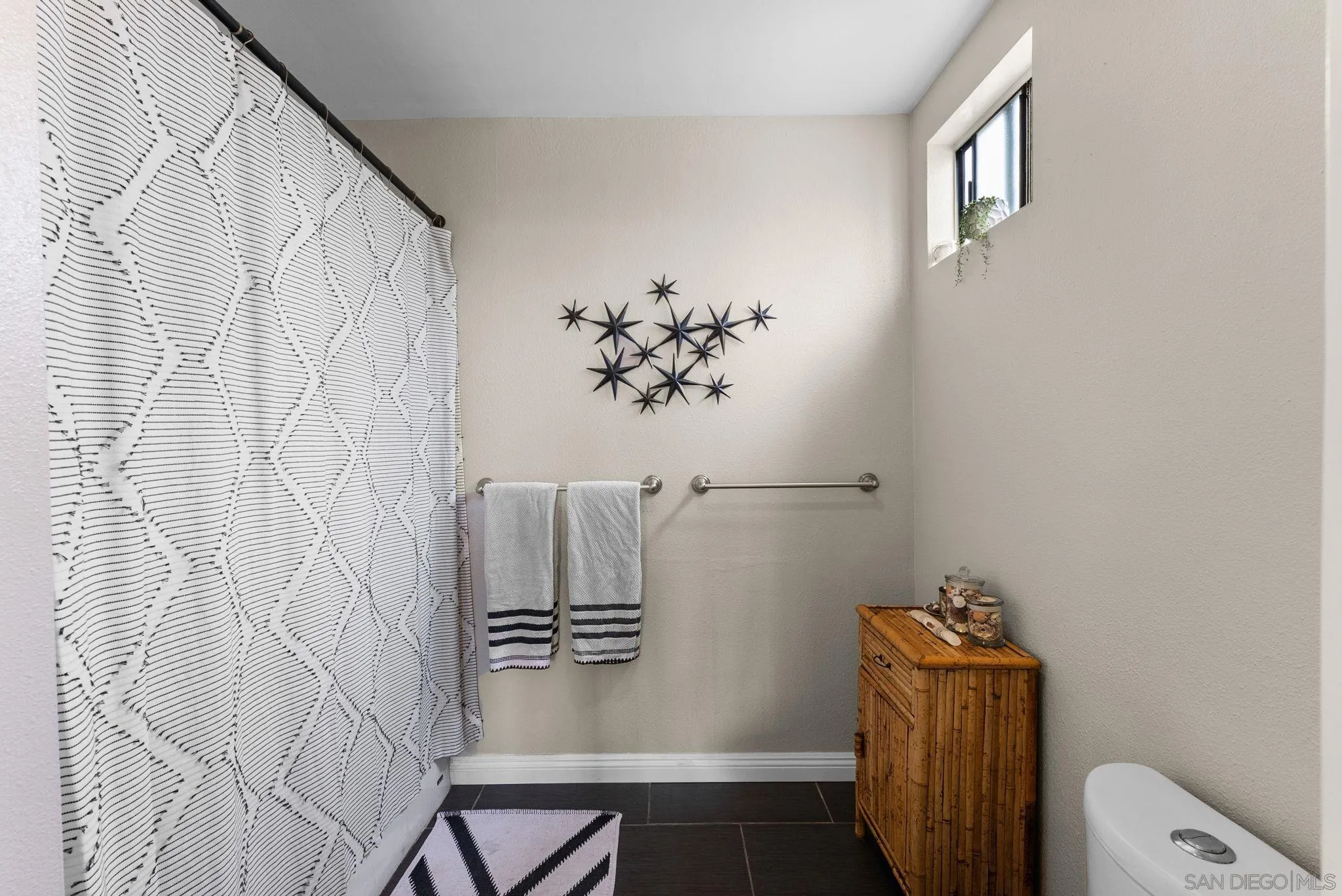 4444 Silver Birch Way Oceanside, CA 92057 - Photo 19 of 54 a bathroom with a shower curtain and a sink