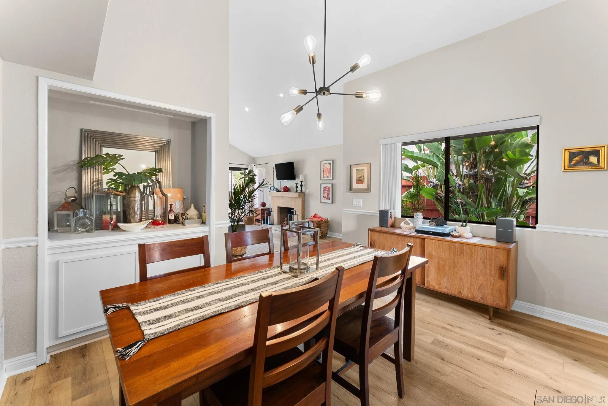 4444 Silver Birch Way Oceanside, CA 92057 - Photo 9 of 54 a dining room with wooden floor a chandelier a wooden table and chairs