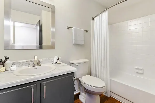 a bathroom with a sink toilet and shower