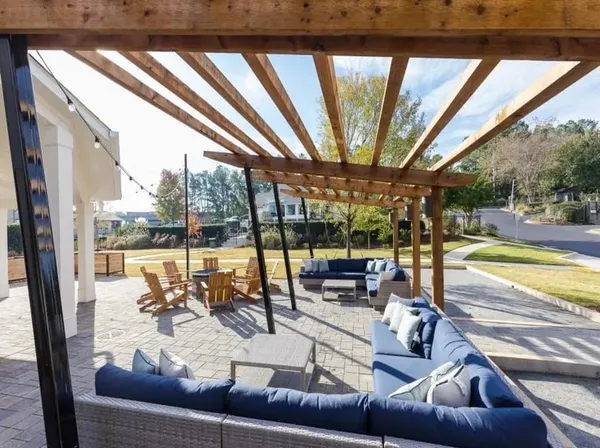 a view of a swimming pool with outdoor seating