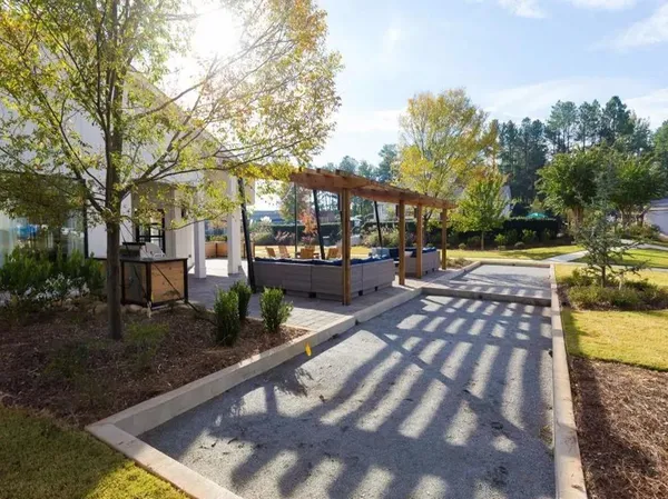 a view of a yard with plants and trees