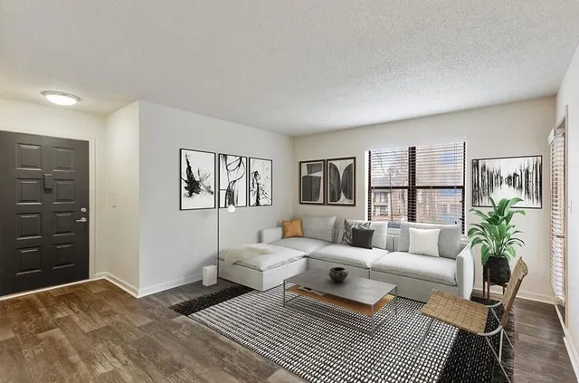 a living room with furniture and a lamp