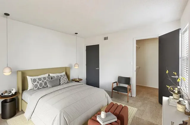 a bedroom with a bed and a chair