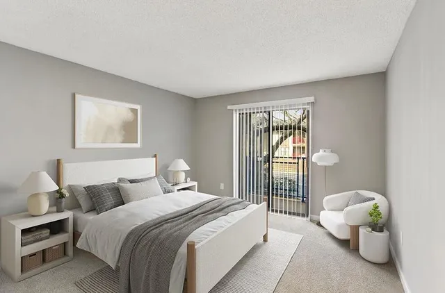 a bedroom with bed and a large window