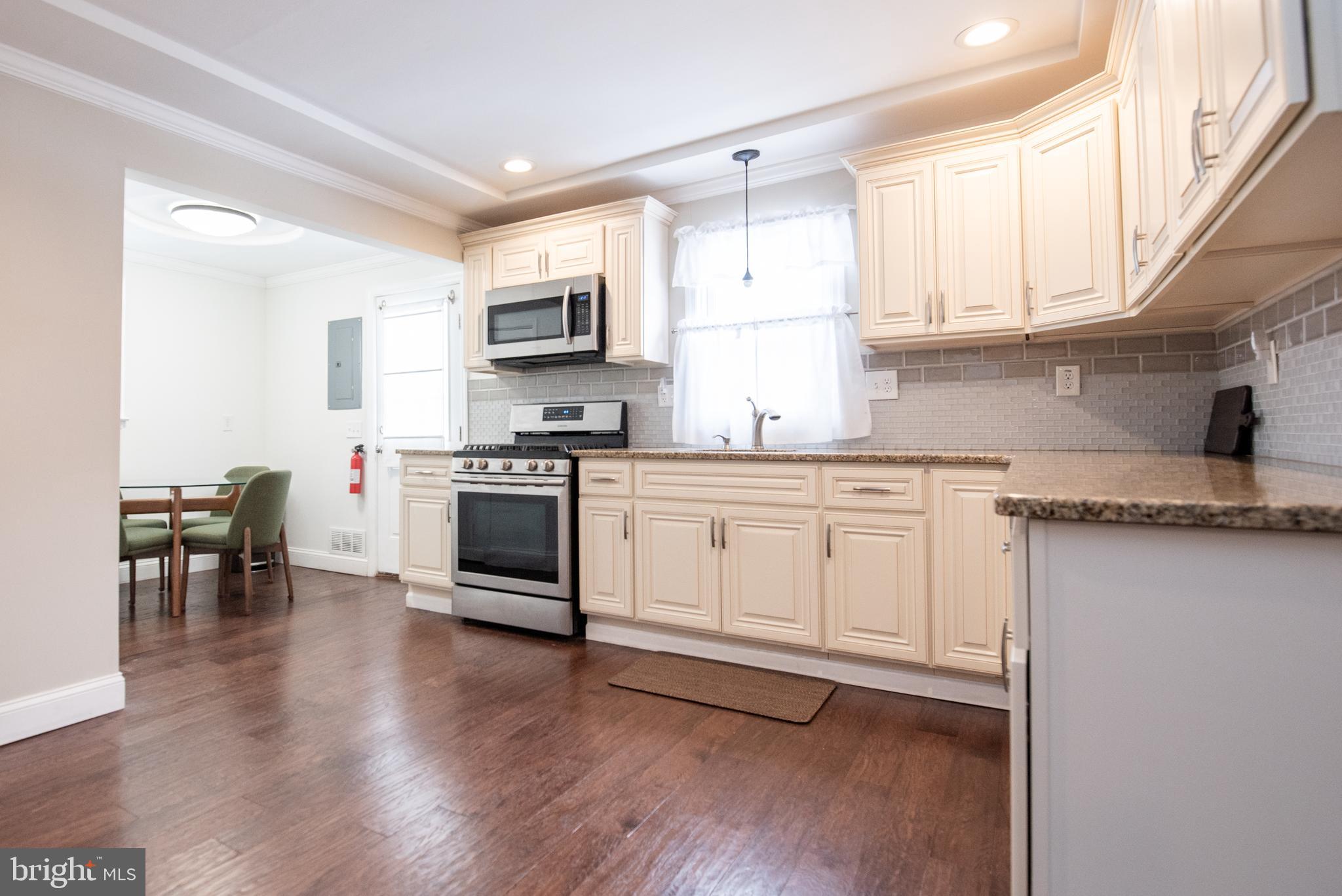 452 Elm Avenue Maple Shade, NJ 08052 - Photo 6 of 31 a kitchen with stainless steel appliances a white stove top oven sink and cabinets