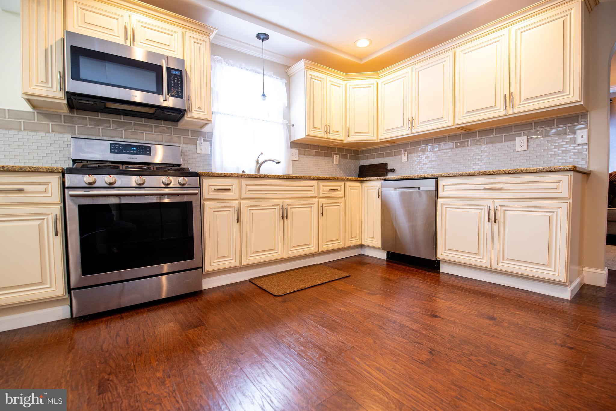 452 Elm Avenue Maple Shade, NJ 08052 - Photo 7 of 31 a kitchen with stainless steel appliances granite countertop a stove a microwave and cabinets