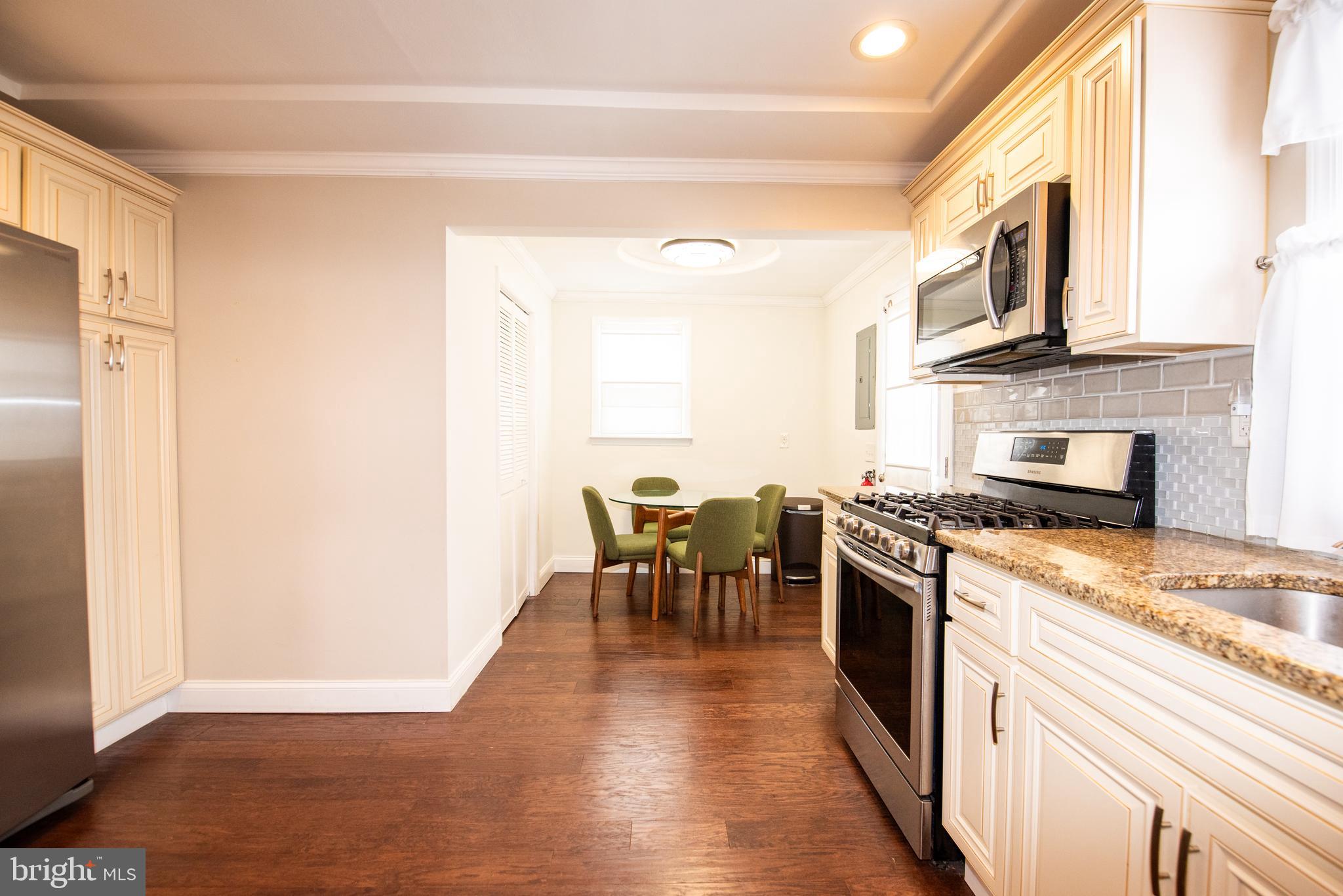 452 Elm Avenue Maple Shade, NJ 08052 - Photo 10 of 31 a kitchen with stainless steel appliances granite countertop a stove top oven a sink and a refrigerator
