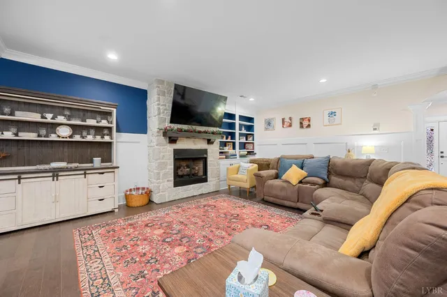 a living room with furniture a fireplace and a flat screen tv