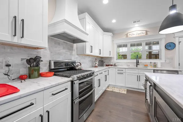 a large kitchen with stainless steel appliances lots of counter space