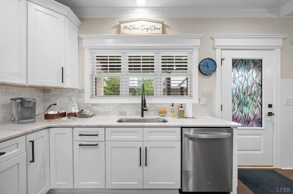 a kitchen with stainless steel appliances granite countertop a sink a stove a refrigerator and island with wooden floor