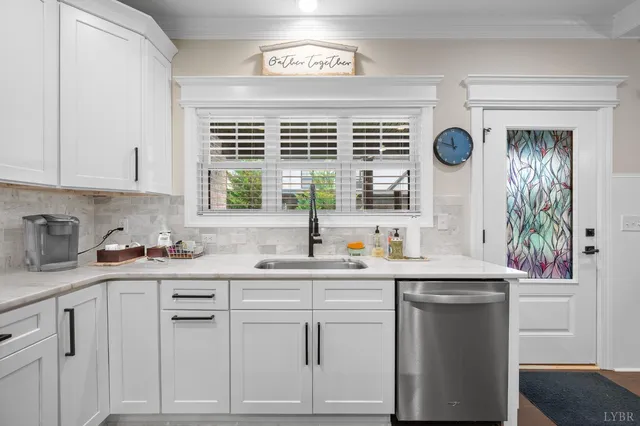 a kitchen with stainless steel appliances granite countertop a sink a stove a refrigerator and island with wooden floor