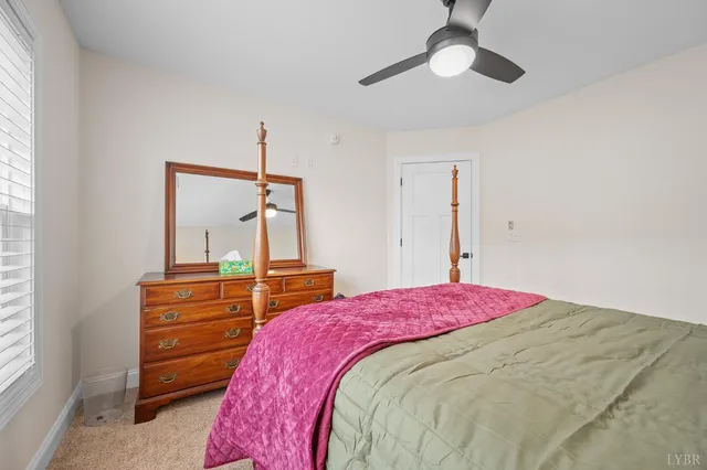 a view of a workspace with furniture and a book shelf
