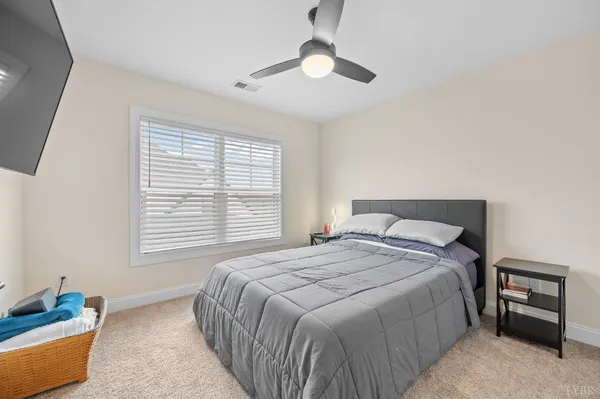 a bedroom with a bed and a large mirror