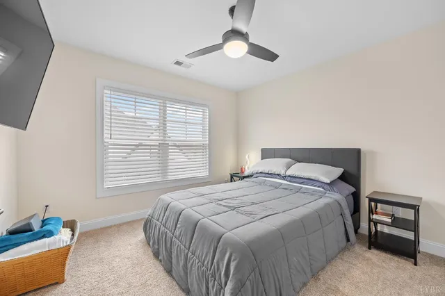 a bedroom with a bed and a large mirror